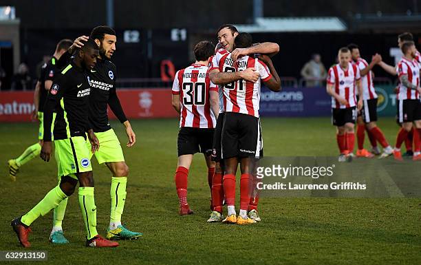 Fikayo Tomori of Brighton and Hove Albion is consoled by his team mates after scoring an own goal while Lincoln City players celebrate their second...