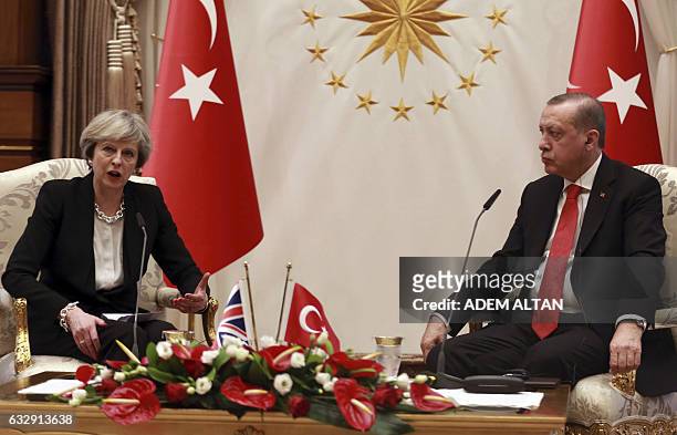 Turkey's President Recep Tayyip Erdogan and British Prime Minister Theresa May speak during a meeting at the presidential complex in Ankara on...