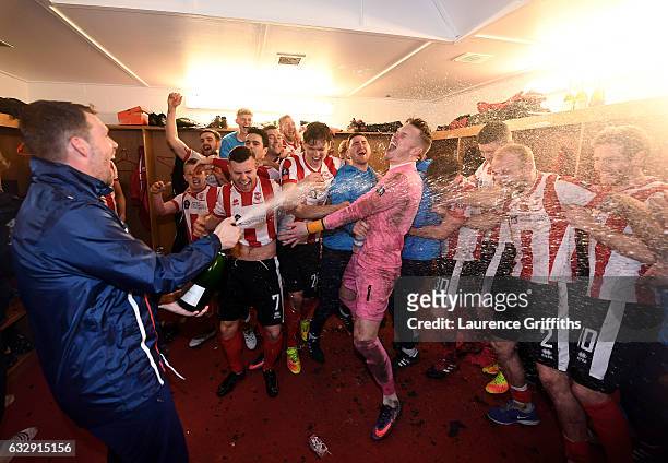 Lincoln City players celebrate their win in the changing room after the Emirates FA Cup Fourth Round match between Lincoln City and Brighton and Hove...