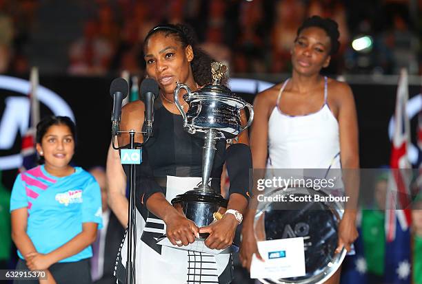 Serena Williams speaks with the Daphne Akhurst Trophy after winning the Women's Singles Final against Venus Williams of the United States, posing...