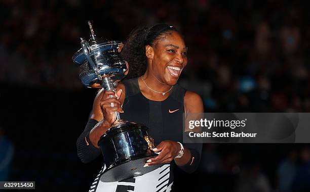 Serena Williams poses with the Daphne Akhurst Trophy after winning the Women's Singles Final against Venus Williams of the United States on day 13 of...