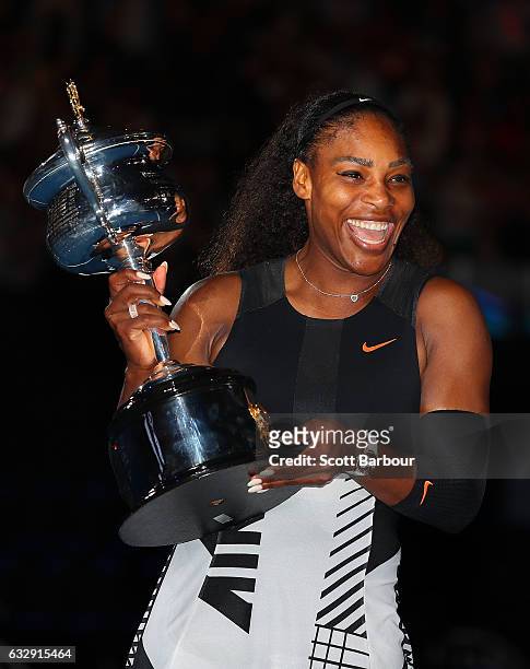 Serena Williams poses with the Daphne Akhurst Trophy after winning the Women's Singles Final against Venus Williams of the United States on day 13 of...
