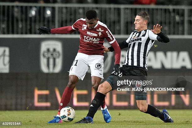 Metz's French forward Opa N'Guette vies with Angers's Algerian defender Mehdi Tahrat during the French L1 football match between Angers and Metz , on...