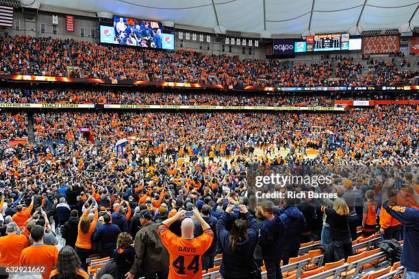 Syracuse Orange fans rush the court following the game against the Florida State Seminoles at the Carrier Dome on January 28, 2017 in Syracuse, New...