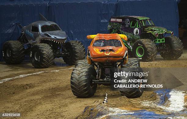 Monster trucks perform during the Monster Jam show at the Verizon Center in Washington, DC on January 28, 2017. / AFP / Andrew CABALLERO-REYNOLDS