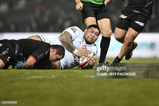 Racing 92's New Zealander prop Ben Tameifuna is tackled by Lyon's French hooker Mickael Ivaldi during the French Top 14 rugby union match between...