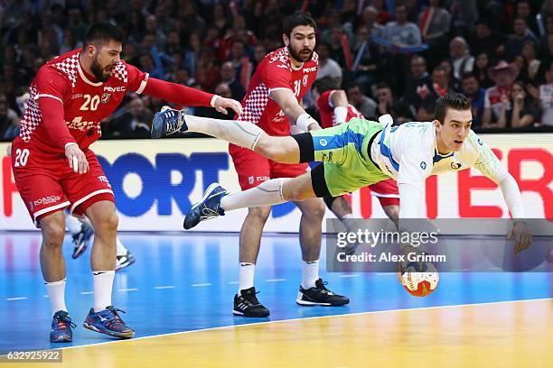 Nik Henigman of Slovenia is challenged by Tin Kontrec of Croatia during the 25th IHF Men's World Championship 2017 Bronze Medal Game between Slovenia...