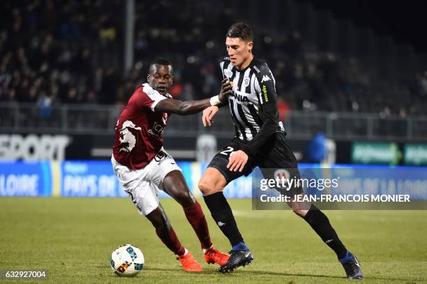 Metz's Senegalese defender Fallou Diagne vies with Angers's Algerian defender Mehdi Tahrat during the French L1 football match between Angers and...