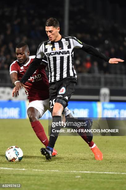 Metz's Senegalese defender Fallou Diagne vies with Angers' Algerian defender Mehdi Tahrat during the French L1 football match between Angers and Metz...