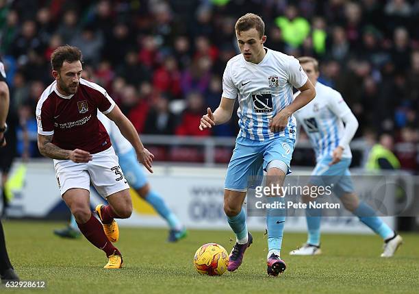 Charles Vernam of Coventry City plays the ball watched by Neal Eardley of Northampton Town during the Sky Bet League One match between Northampton...