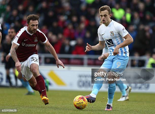 Charles Vernam of Coventry City plays the ball watched by Neal Eardley of Northampton Town during the Sky Bet League One match between Northampton...