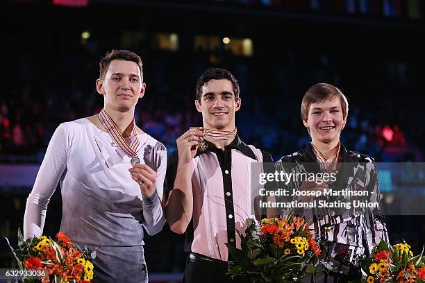 Maxim Kovtun of Russia, Javier Fernandez of Spain and Mikhail Kolyada of Russia pose in the Men's medal ceremony during day 4 of the European Figure...