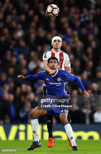 Ruben Loftus-Cheek of Chelsea and John Egan of Brentford compete for the ball during the Emirates FA Cup fourth round match between Chelsea and...