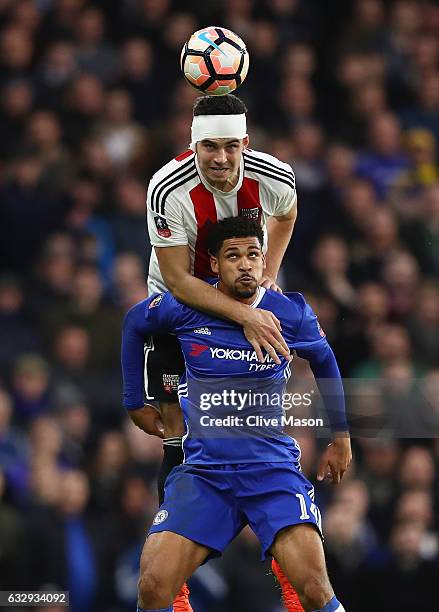 Ruben Loftus-Cheek of Chelsea and John Egan of Brentford compete for the ball during the Emirates FA Cup fourth round match between Chelsea and...