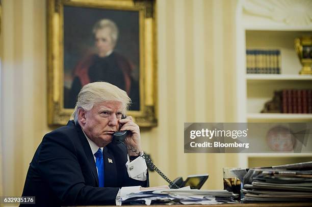 President Donald Trump speaks on the phone with Malcolm Turnbull, Australia's prime minister, during the first official phone talks in the Oval...