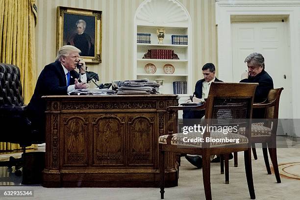 President Donald Trump, left, speaks on the phone with Malcolm Turnbull, Australia's prime minister, as retired Lieutenant General Michael Flynn,...