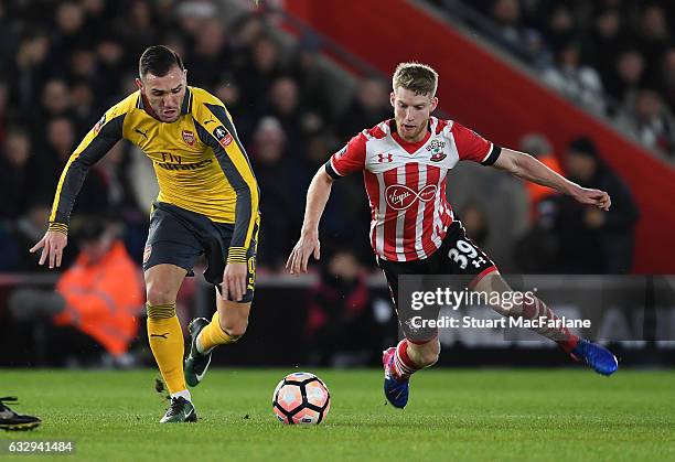 Lucas Perez of Arsenal takes on Josh Sims of Southampton during the Emirates FA Cup Fourth Round match between Southampton and Arsenal at St Mary's...