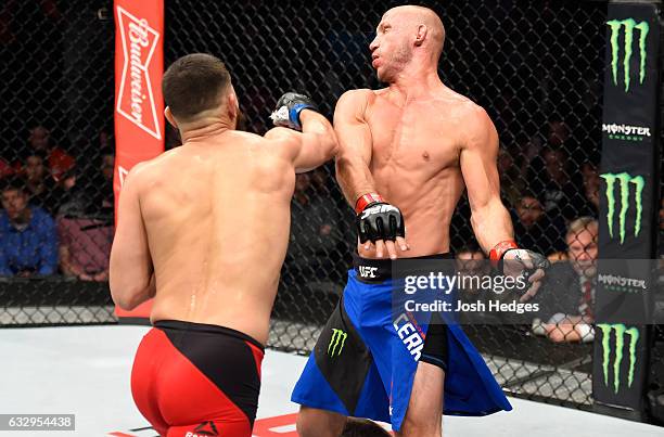 Jorge Masvidal punches Donald Cerrone in their welterweight bout during the UFC Fight Night event at the Pepsi Center on January 28, 2017 in Denver,...