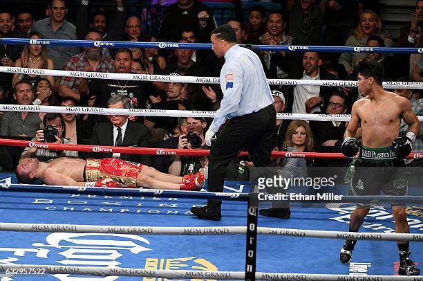 Referee Tony Weeks checks on Dejan Zlaticanin after he was knocked out by Mikey Garcia in the third round of their WBC lightweight title fight at MGM...