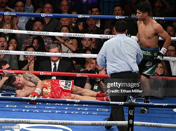 Referee Tony Weeks directs Mikey Garcia to a neutral corner after he knocked out Dejan Zlaticanin in the third round of their WBC lightweight title...