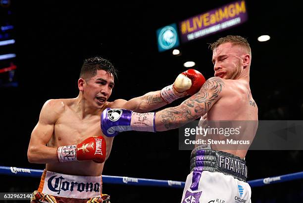 Leo Santa Cruz lands a punch on Carl Frampton during their WBA featherweight title fight at MGM Grand Garden Arena on January 28, 2017 in Las Vegas,...