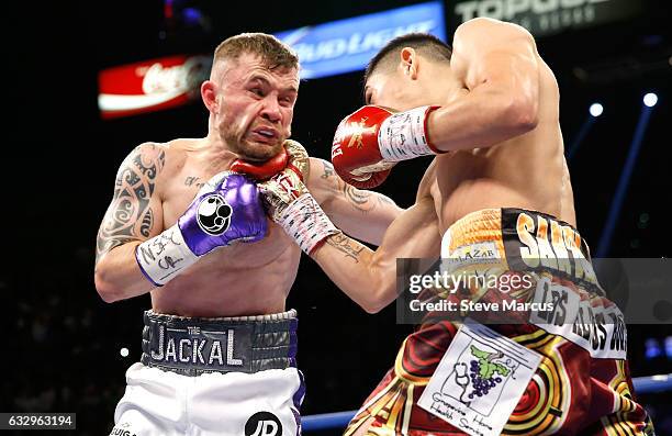 Carl Frampton gets hit by Leo Santa Cruz during their WBA featherweight title fight at MGM Grand Garden Arena on January 28, 2017 in Las Vegas,...