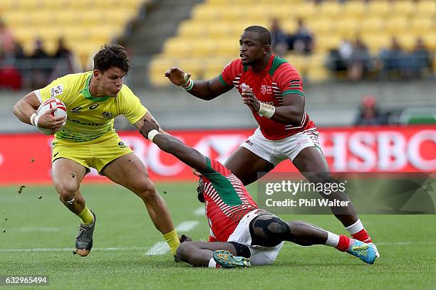 Simon Kennewell of Australia is tackled during the Trophy final against Kenya during the 2017 Wellington Sevens at Westpac Stadium on January 29,...