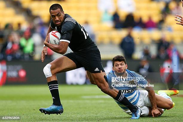 Sione Molia of New Zealand attempts to beat the defence of Lautaro Bazan Velez of Argentina in the 5th Place Play-Off match between New Zealand and...