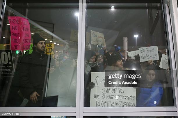 Activists stage a rally against President Donald Trump's 90-days ban of entry on 7 Muslim-majority countries in the Fourth terminal of JFK airport in...