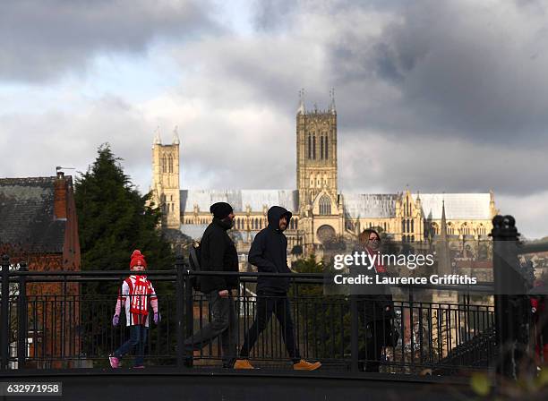 Young fans walks to the stadium in front of Lincoln Cathedral ahead of the Emirates FA Cup Fourth Round match between Lincoln City and Brighton and...