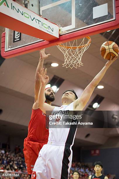 Ryo Kubota of the Osaka Evessa tries to shoot under pressure from Michael Parker of the Chiba Jets during the B. League game between Chiba Jets and...