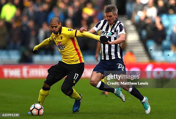 Adlene Guedioura of Watford holds back Steve Morison of Millwall during The Emirates FA Cup Fourth Round match between Millwall and Watford at The...