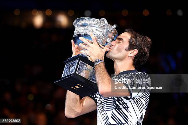 Roger Federer of Switzerland kisses the Norman Brookes Challenge Cup after winning the Men's Final match against Rafael Nadal of Spain on day 14 of...