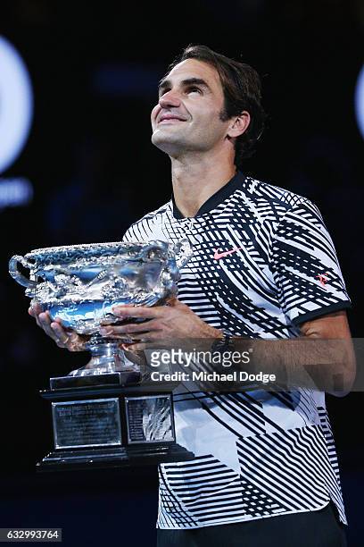 Roger Federer of Switzerland celebrates with the Trophy after winning against Raphael Nadal of Spain in the Men's Final match against on day 14 of...