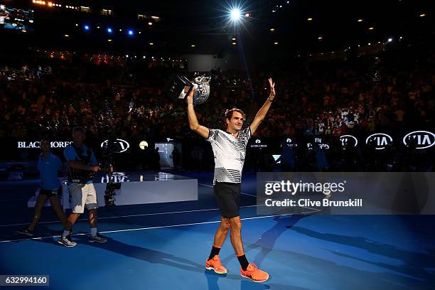 Roger Federer of Switzerland poses with the Norman Brookes Challenge Cup after winning the Men's Final match against Rafael Nadal of Spain on day 14...