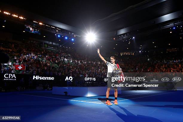 Roger Federer of Switzerland thanks the crowd with the Norman Brookes Challenge Cup after winning the Men's Final match against Rafael Nadal of Spain...