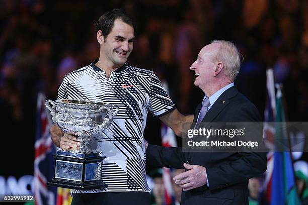 Australian tennis legend Rod Laver hugs Roger Federer of Switzerland who celebrates with the Trophy after winning in the Men's Final match against on...