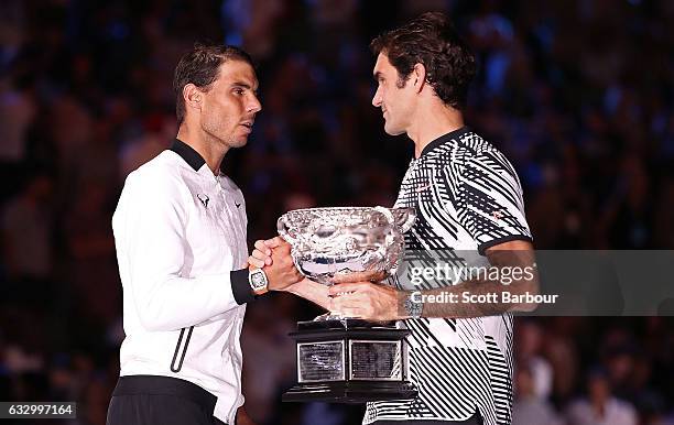 Rafael Nadal of Spain congratulates Roger Federer of Switzerland on winning their Men's Final as Roger Federer holds the Norman Brookes Challenge Cup...