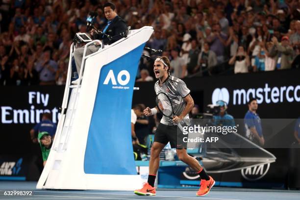 Switzerland's Roger Federer celebrates his victory against Spain's Rafael Nadal during the men's singles final on day 14 of the Australian Open...