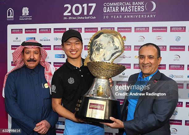 Jeunghun Wang of South Korea receives the trophy from Hassan Al Naimi the President of the Qatar Golf Association and Joseph Abraham the CEO of...