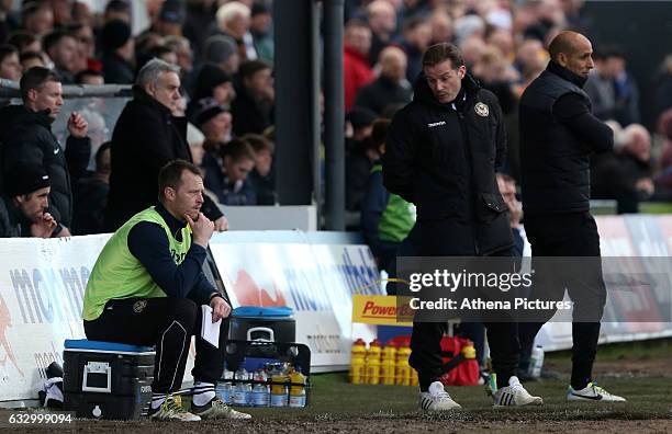 Coach and player Michael Flynn talks with Graham Westley of Newport County AFC during the Sky Bet League Two match between Newport County and...