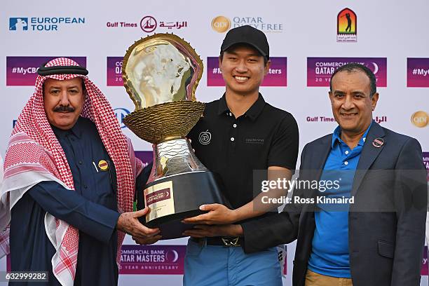 Jeunghun Wang of South Korea receives the trophy from Hassan Al Naimi the President of the Qatar Golf Association and Joseph Abraham the CEO of...