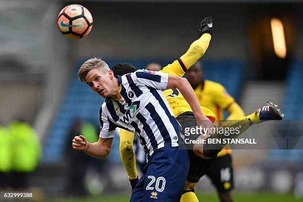 Millwall's English-born Welsh striker Steve Morison vies with Watford's Uruguayan defender Miguel Britos during the English FA Cup fourth round...
