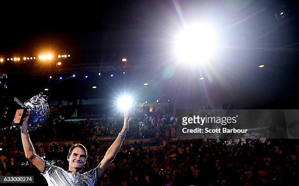 Roger Federer of Switzerland waves to fans in the crowd as he does a lap of honour with the Norman Brookes Challenge Cup after winning the Men's...