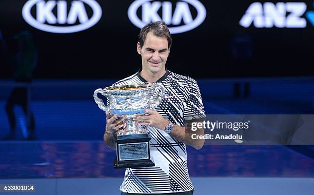 Roger Federer of Switzerland poses with the championship trophy after Australian Open 2017 men's final match against Rafael Nadal of Spain at Rod...