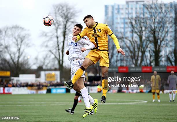 Paul McKay of Leeds United and Maxime Biamou of Sutton United battle to win a header during The Emirates FA Cup Fourth Round match between Sutton...