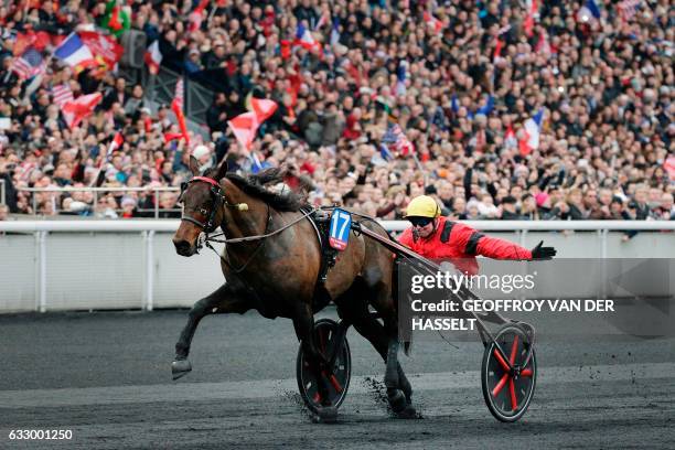 French jockey Franck Nivard, riding horse "Bold Eagle," crosses the finish line to win the 97th Prix d'Amerique equestrian trotting world...