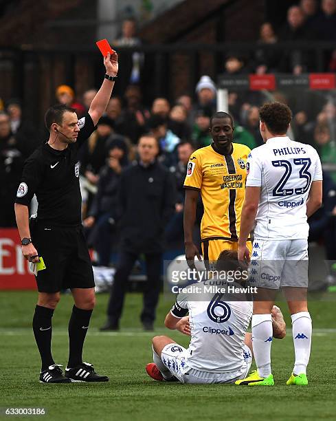 Referee Stuart Attwell gives a red card too Liam Cooper of Leeds United during The Emirates FA Cup Fourth Round match between Sutton United and Leeds...