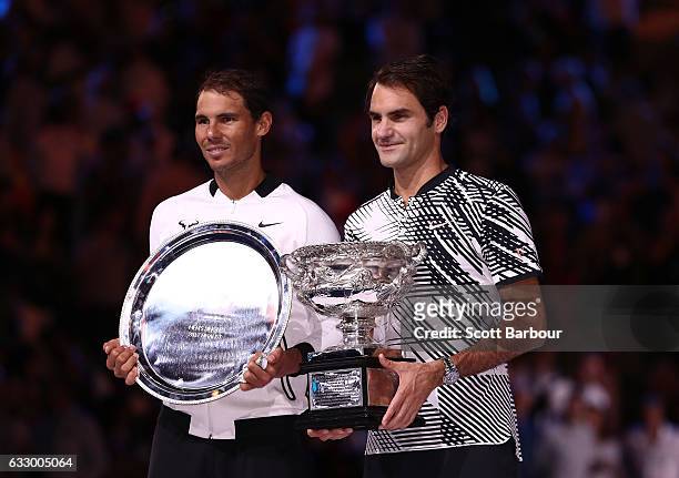 Roger Federer of Switzerland poses with the Norman Brookes Challenge Cup after winning the Men's Final match against Rafael Nadal of Spain on day 14...