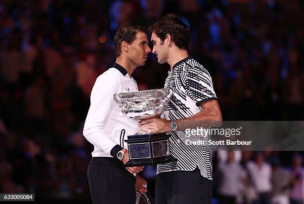 Rafael Nadal of Spain congratulates Roger Federer of Switzerland on winning their Men's Final as Roger Federer holds the Norman Brookes Challenge Cup...